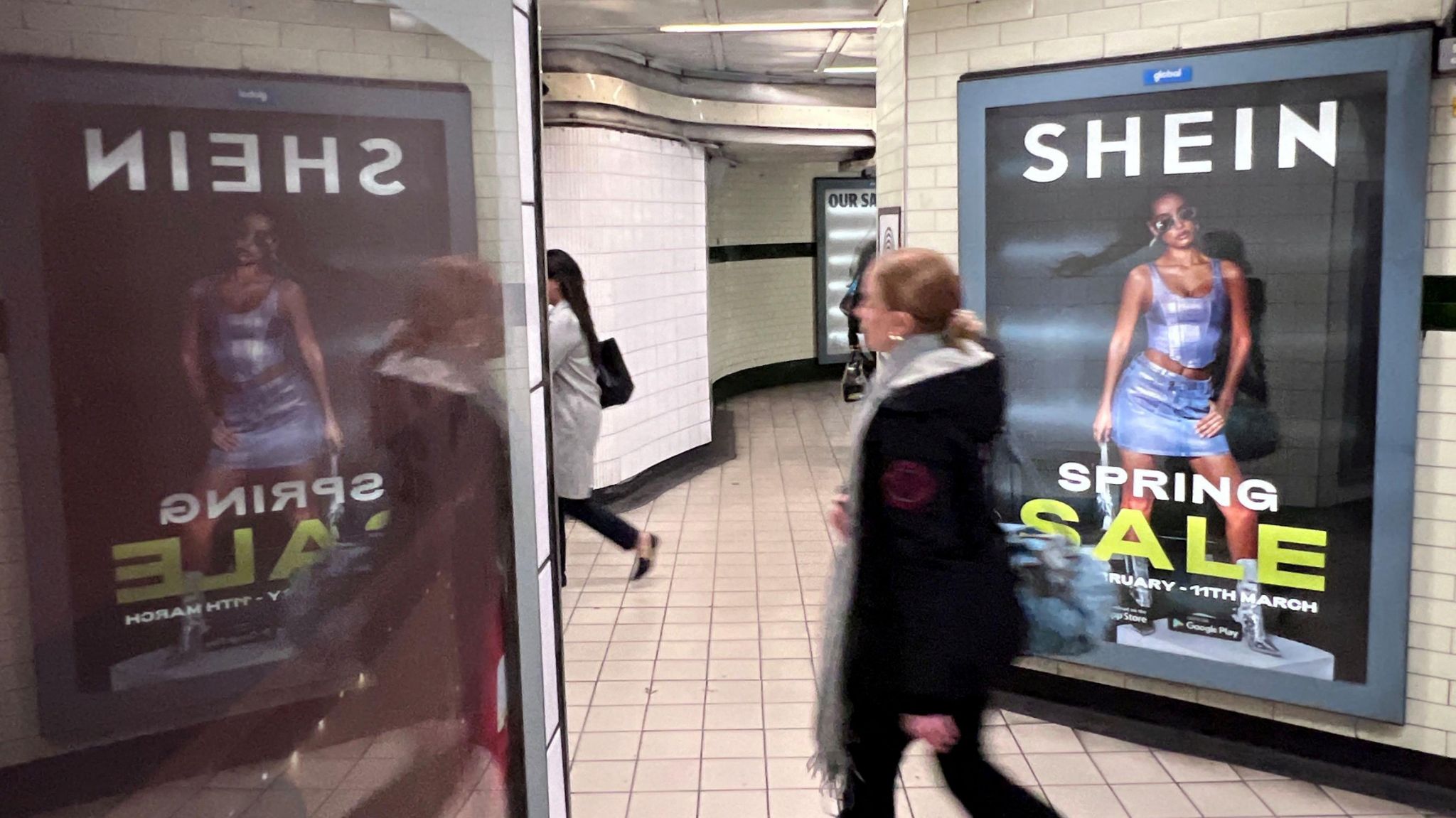  A person walks past an advertisement for Shein, in London.