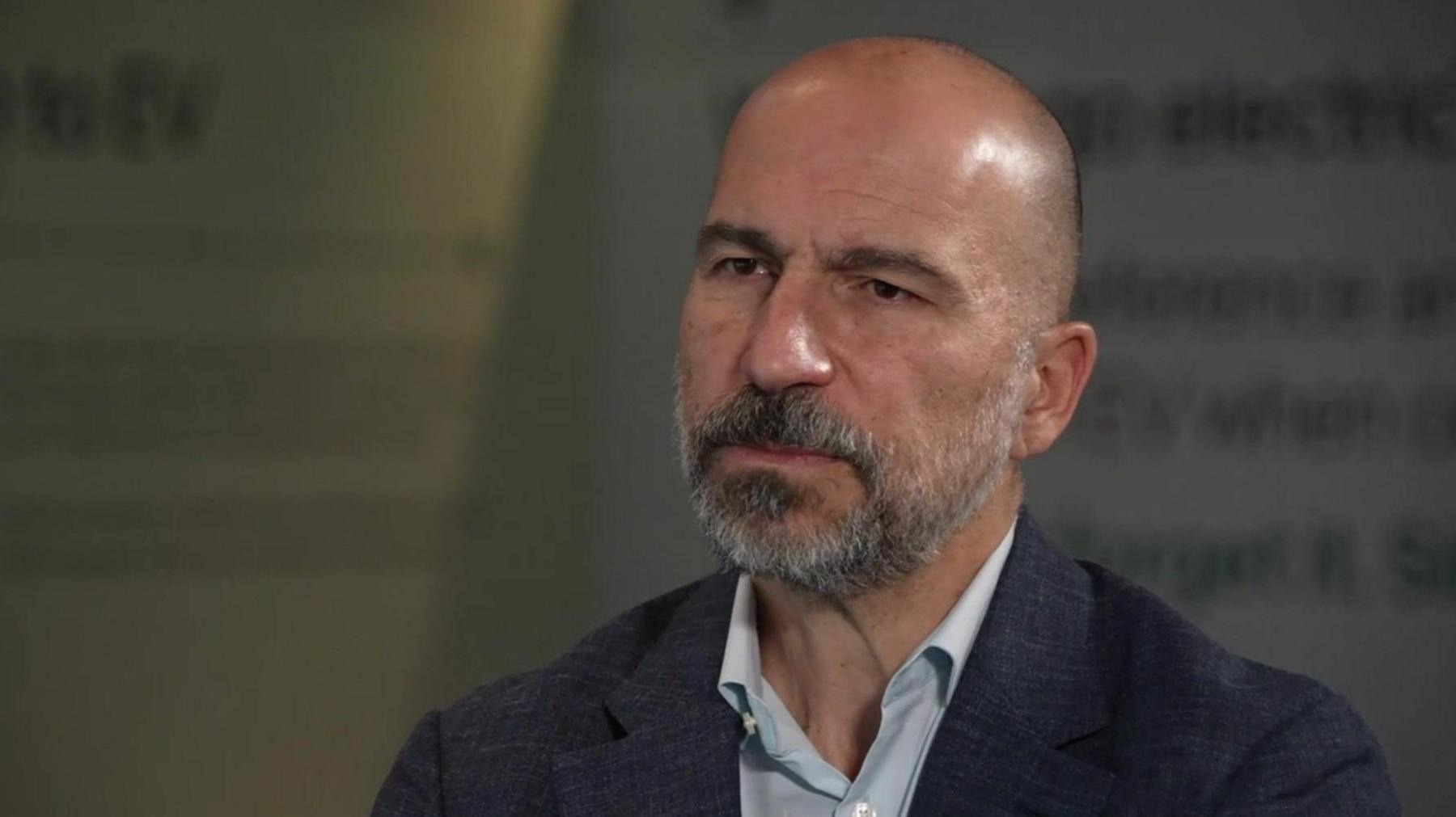 Head and shoulders shot of Dara Khosrowshahi, open neck shirt