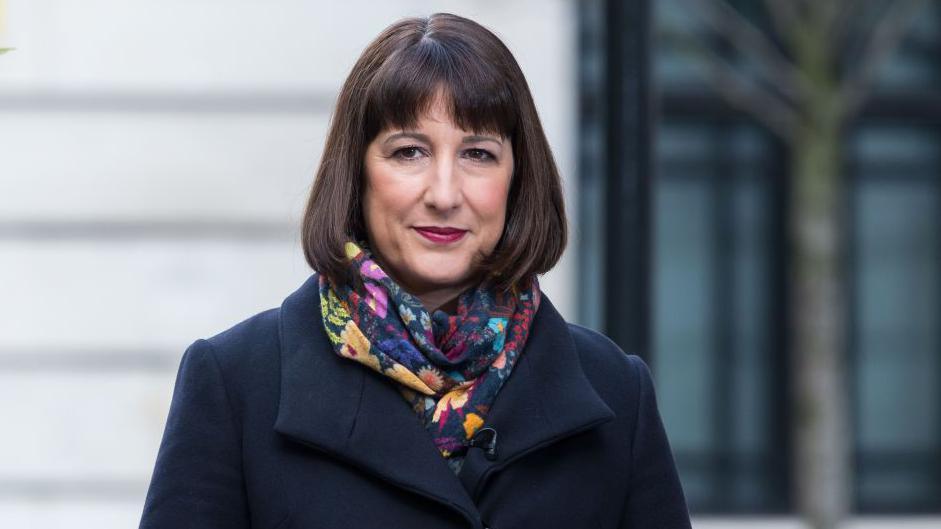 Chancellor Rachel Reeves outside wearing a coat and scarf