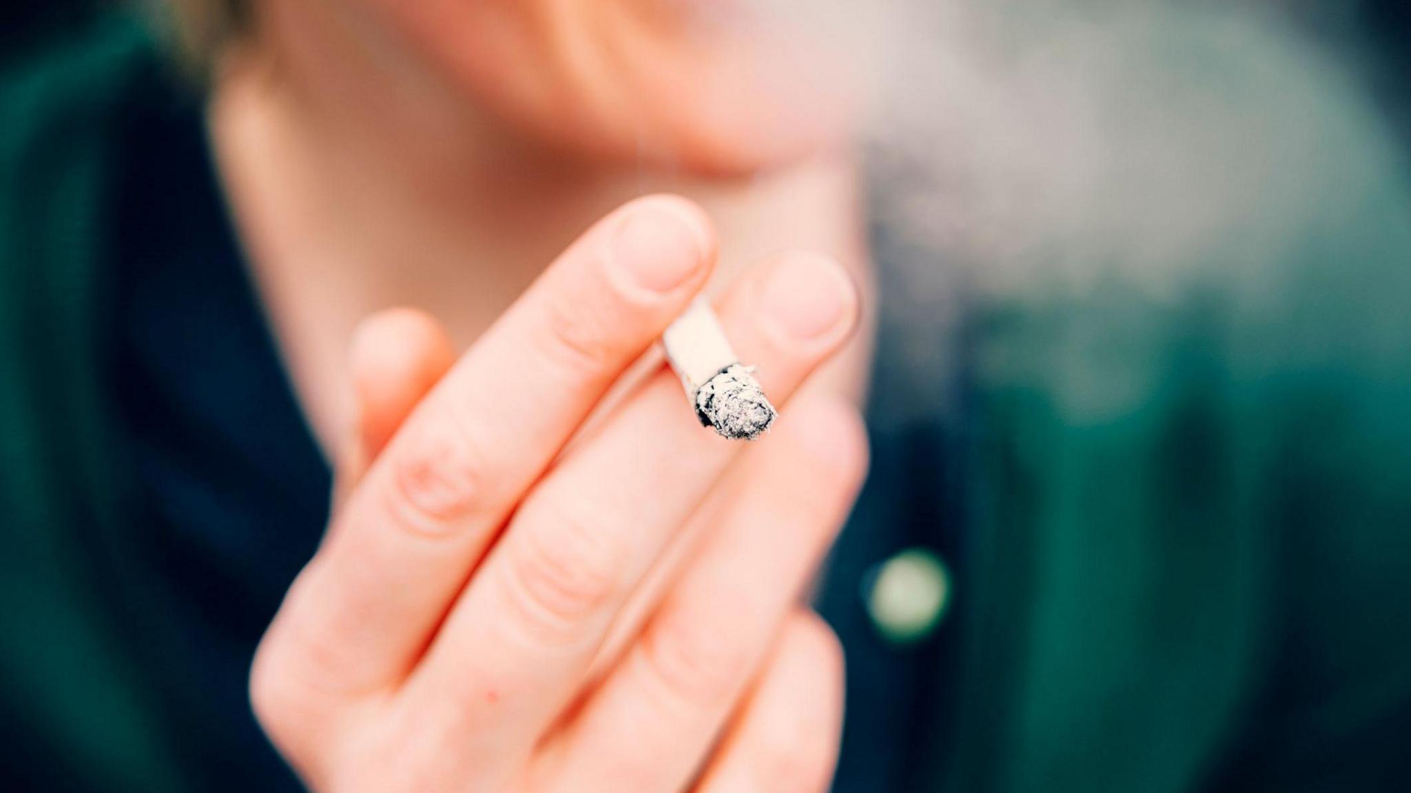 A woman holding a cigarette