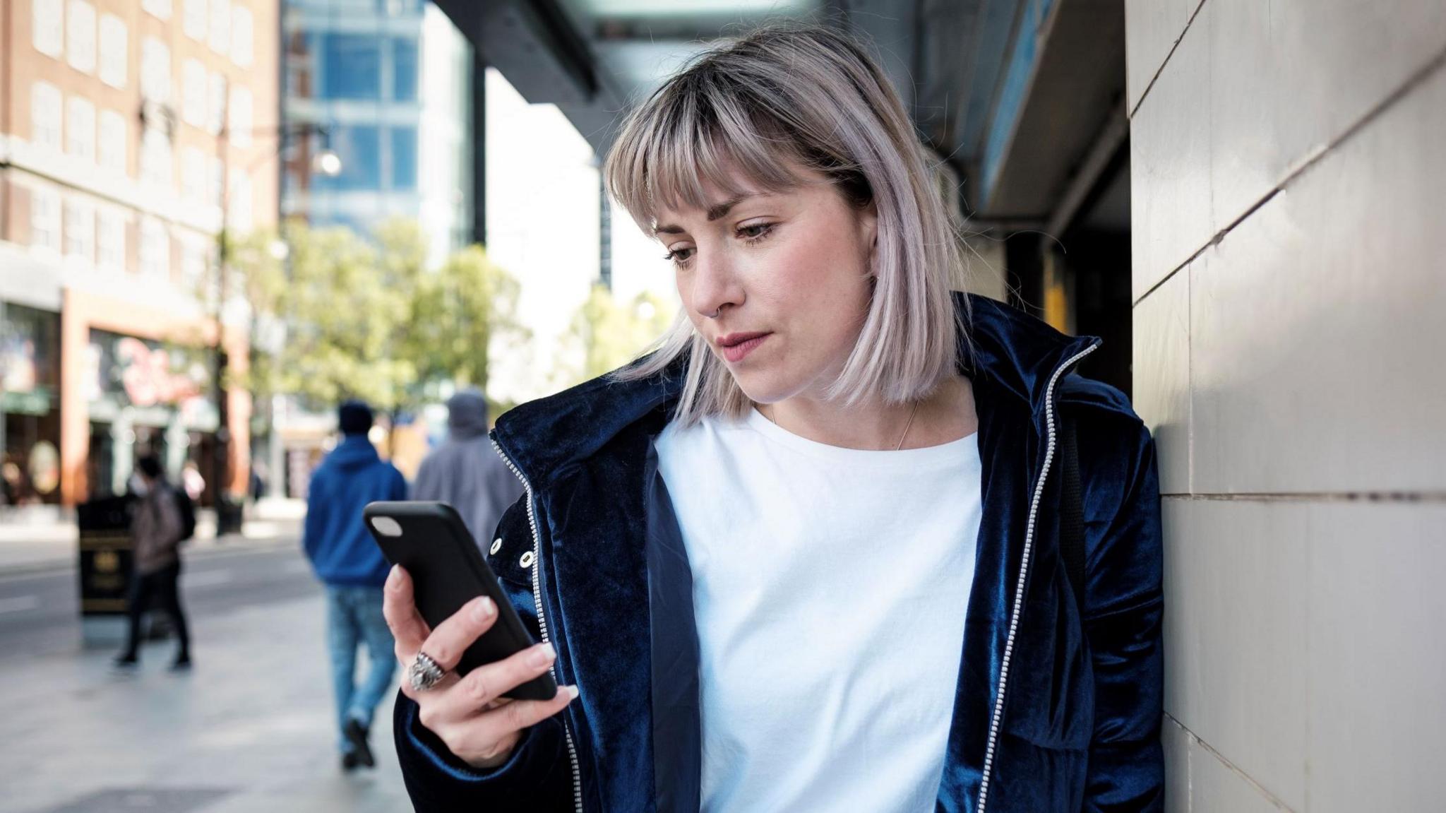 A woman looking at a phone