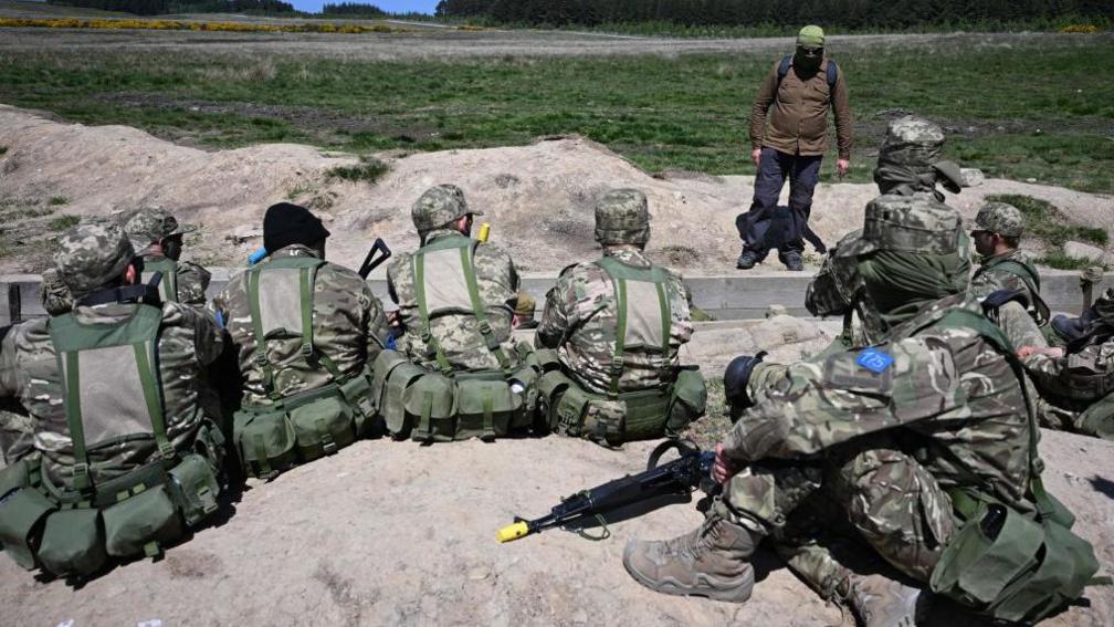 Ukrainian soldiers take part in trench warfare exercises at a British Army military base in Northern England on June 2, 2023