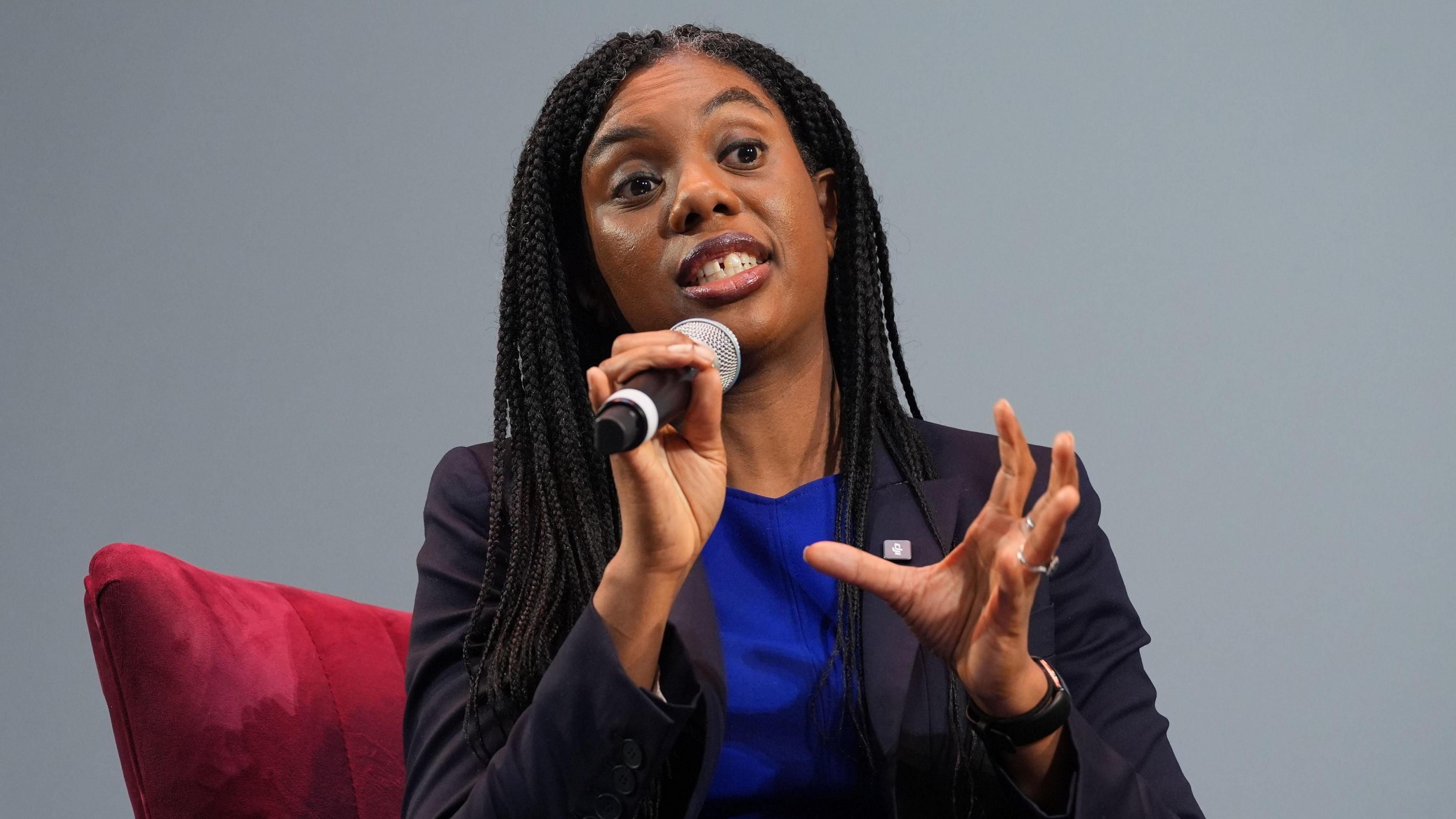 Kemi Badenoch speaks into a microphone at the Business Property Relief summit at the London Palladium