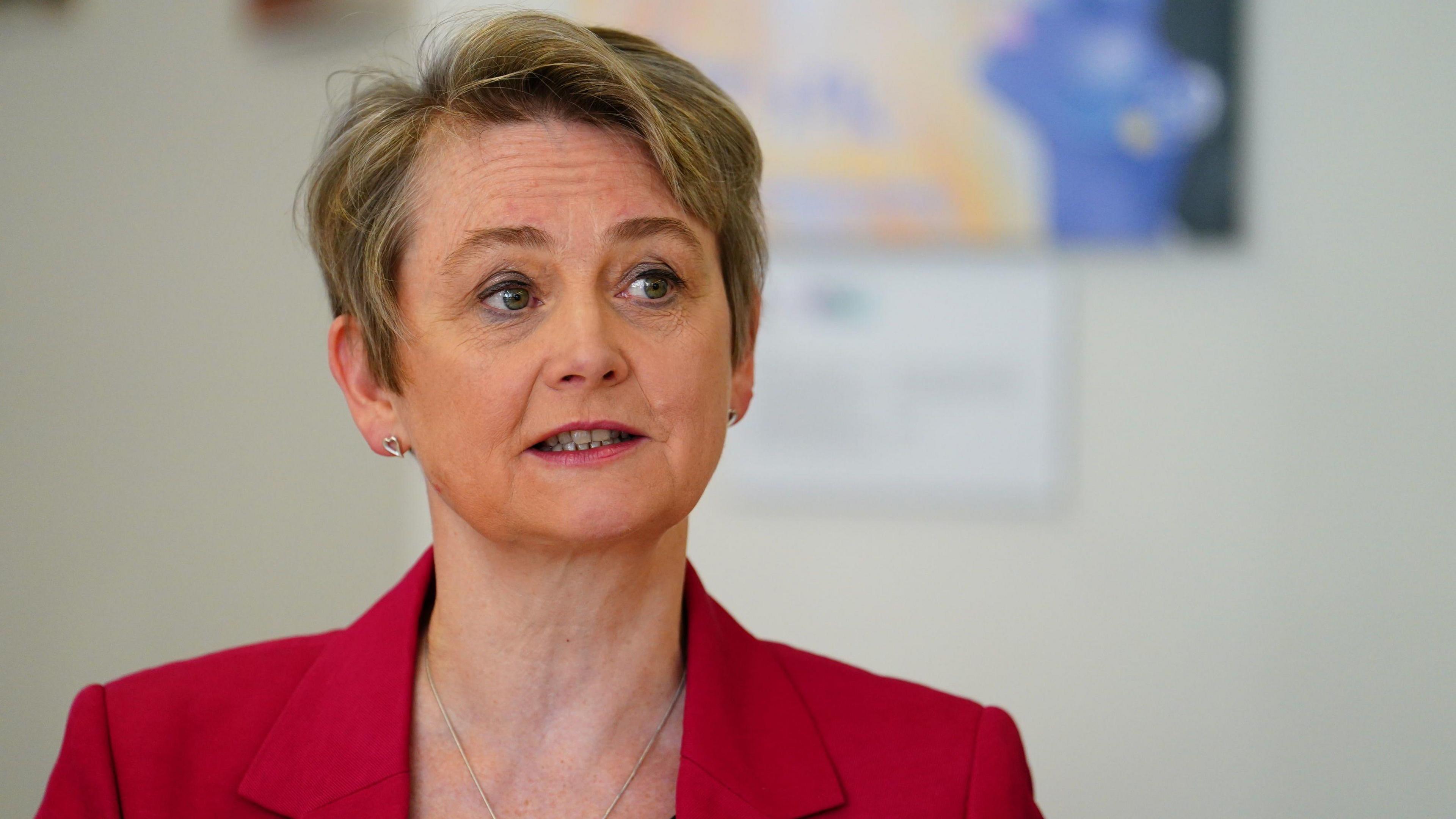 Home Secretary Yvette Cooper wearing a red suit