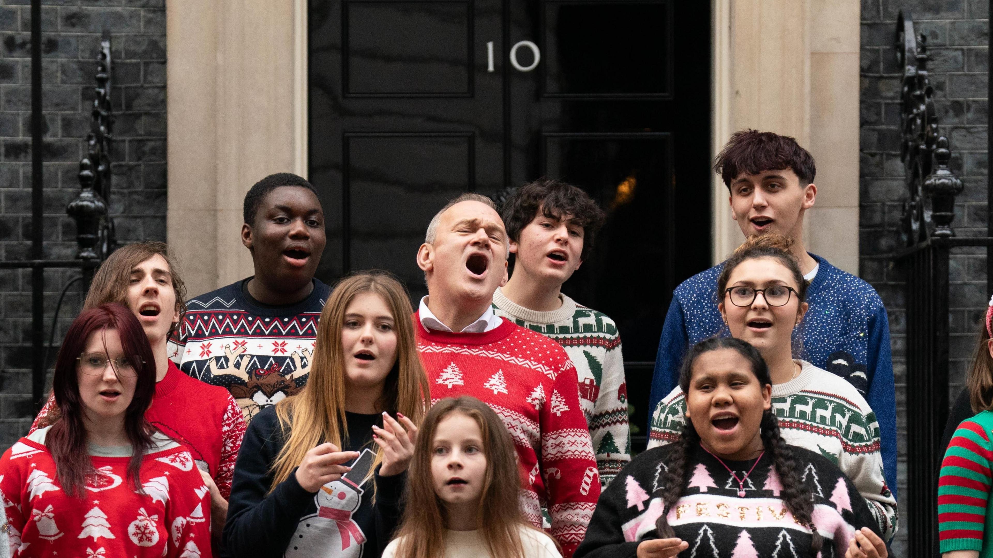 Liberal Democrat leader Sir Ed Davey with the Bath Philharmonia Carers' Choir performing their charity single Love is Enough, outside Number 10