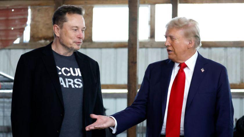 Elon Musk (L) shakes hands with Donald Trump during a rally in Butler, Pennsylvania