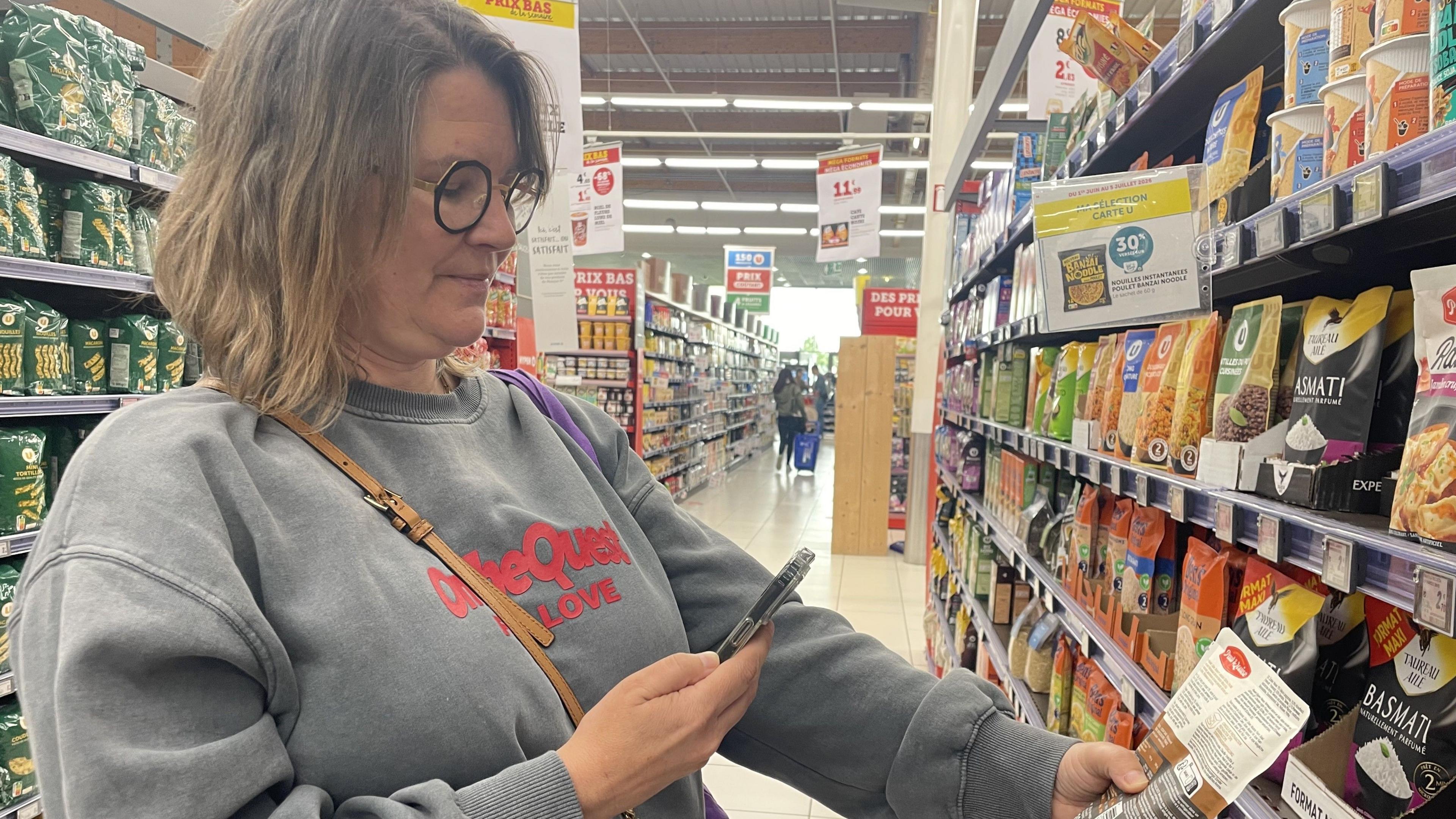 Nathalie uses her phone to scan a product.