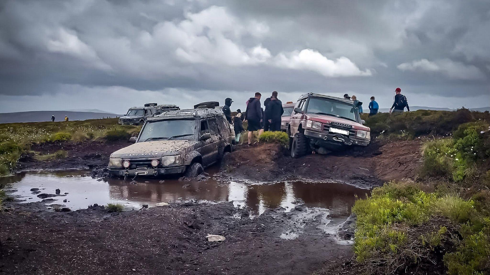 Two 4x4 vehicles are seen trapped in bogland