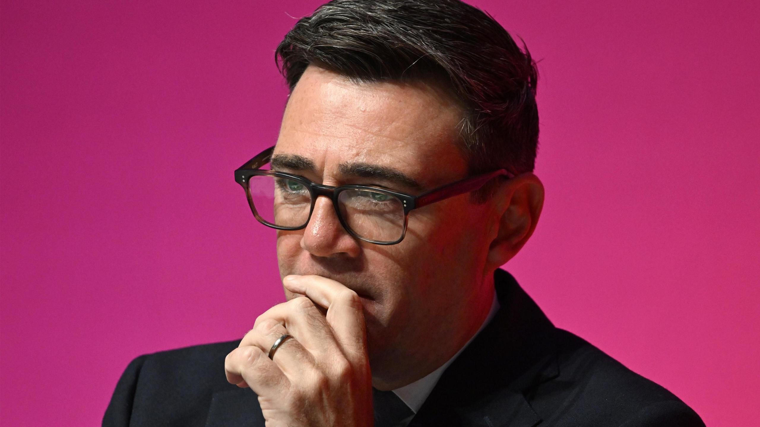 Andy Burnham on the stage at the Labour conference, as he listens to speeches