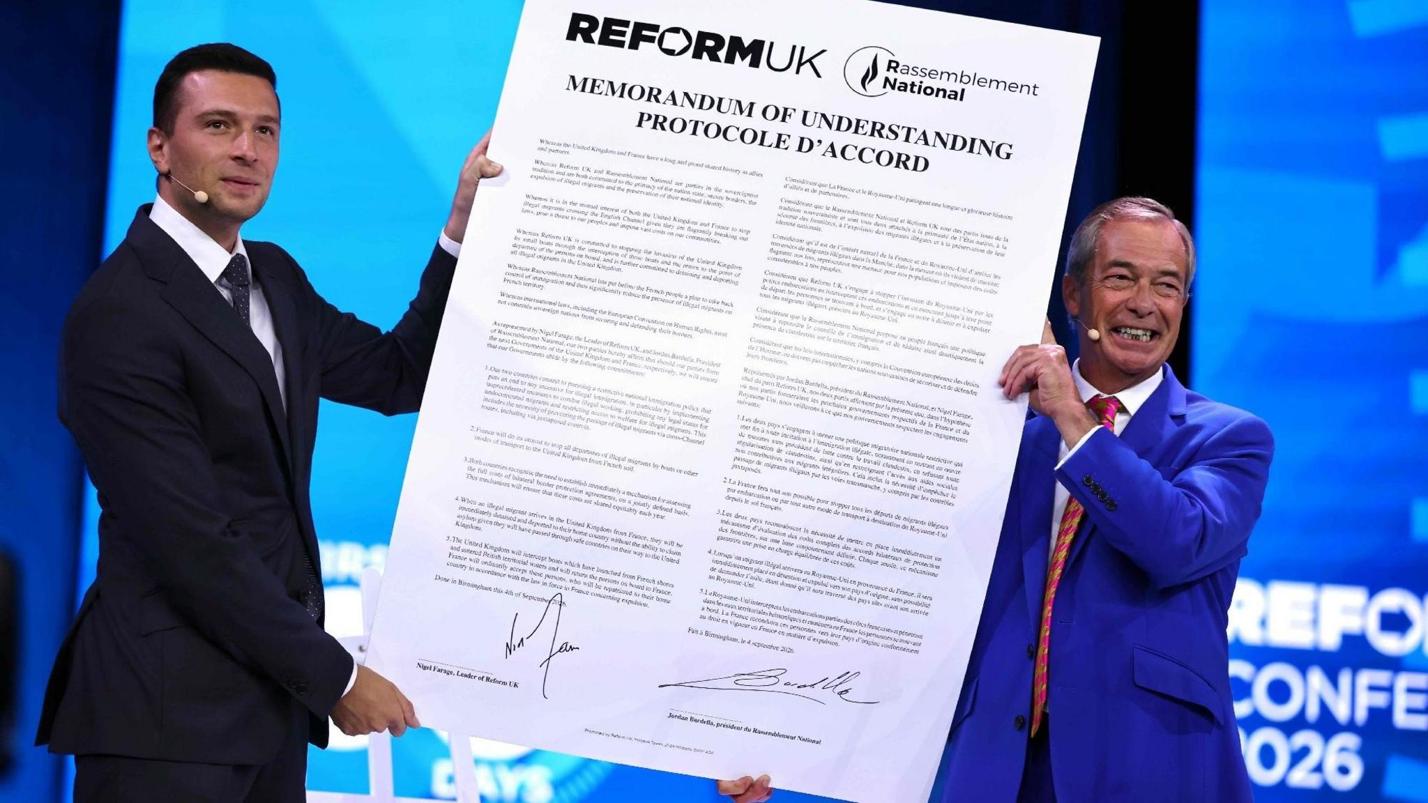 Reform UK leader Nigel Farage and National Rally President Jordan Bardella hold a large version of the proposed agreement