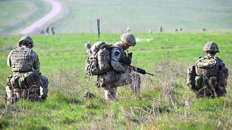 Soldiers from 16 Air Assault Brigade are seen after parachuting from a British Royal Air Force A400M transport aircraft onto Salisbury Plain at Copehill Down training facility in March 2026 as part of Joint Airborne Task Force (JATF) training launched from RAF Brize Norton.