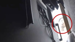 A CCTV still submitted to the criminal complaint against Abdulrahman Alfozan, which appears to show him looking behind a TV, reportedly at the recording device installed there
