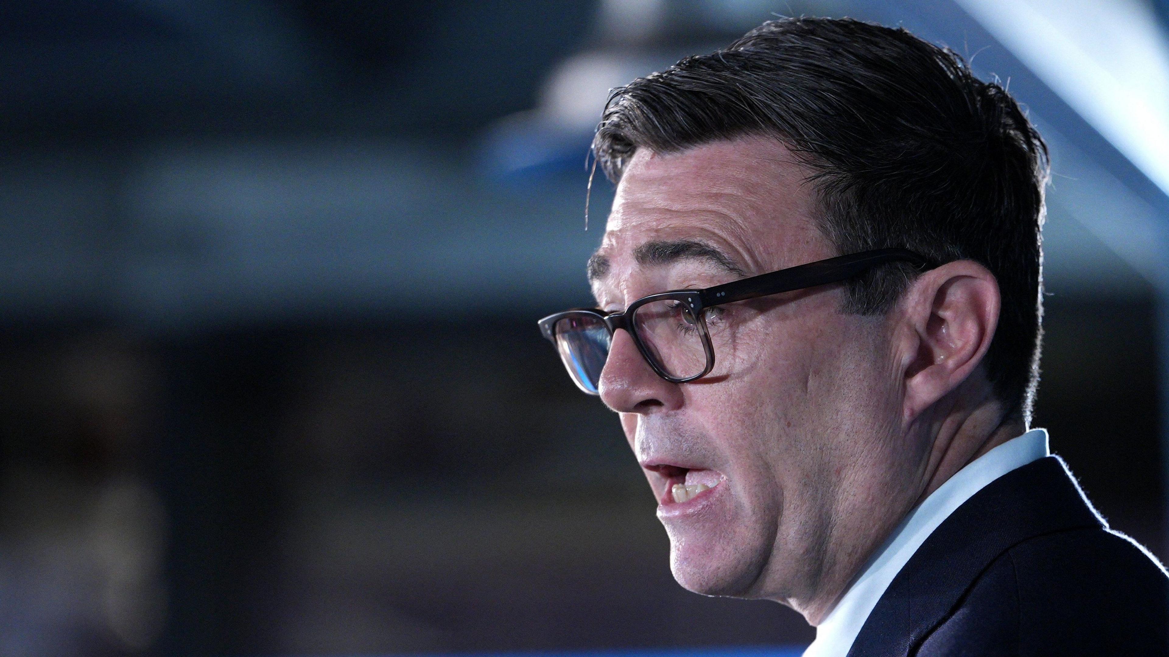 Close-up shot of Andy Burnham's face. The prime minister is wearing a dark suit jacket and light blue shirt. 